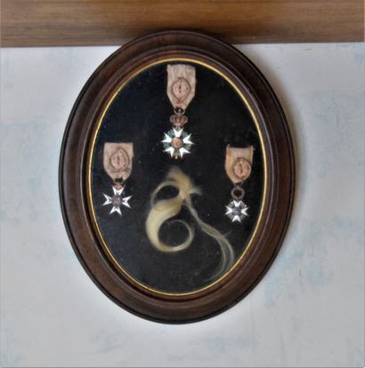 null OVAL FRAME with 3 decorations and a lock of hair.