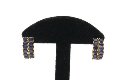 null Pair of earrings in 14K gold alloy (585 thousandths) set with two lines of sapphires...