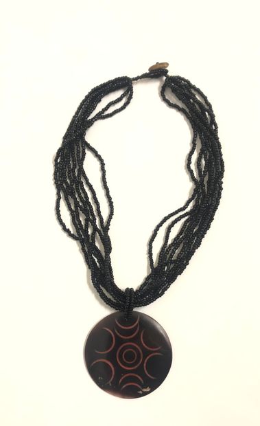 null TWO NECKLACES, one made of wooden beads; - the second with several rows of black...