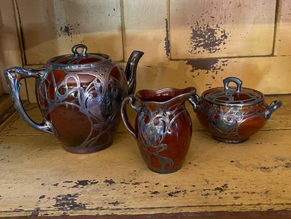 null Three pieces tea set in brown ceramic and metal including: milk jug, teapot,...