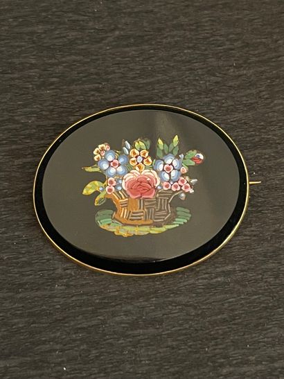 null Oval brooch in micro-mosaic decorated with a flowery basket on black background....