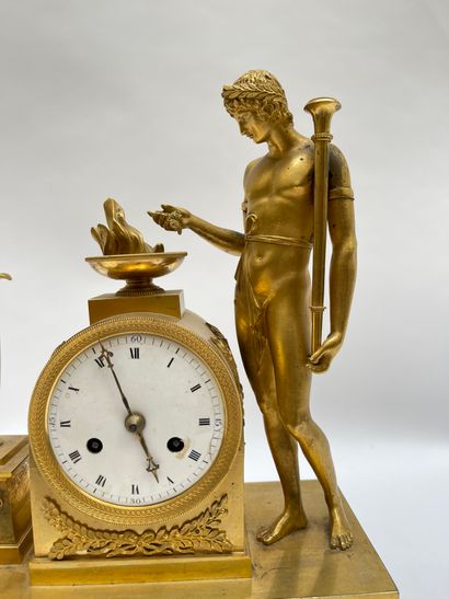 null Gilded bronze clock featuring an undressed man in the antique style feeding...