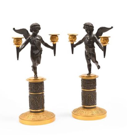 null A pair of two-light candelabra in bronze with a double brown and gold patina,...