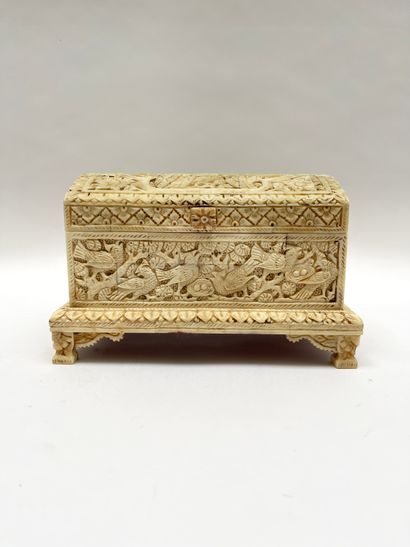 null Quadrangular box with curved lid in bone carved in high relief of vegetation,...