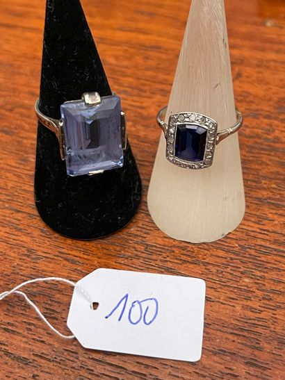 null White gold ring set with a rectangular blue stone in a circle of small diamonds.
Gross...