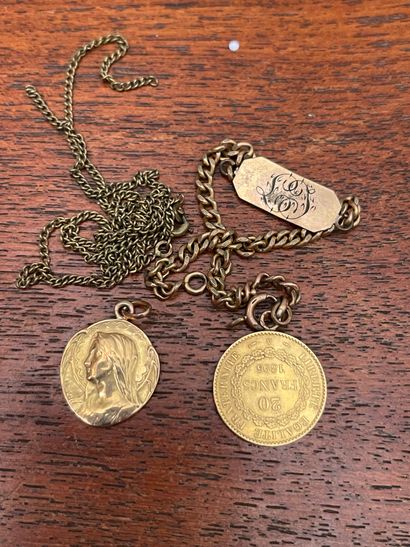 null A 20 Francs gold coin, metal chain; and a gold Virgin medal (NET weight: 1,8...