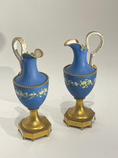 null Pair of cookie ewers with polychrome decoration of flowers on a blue background....