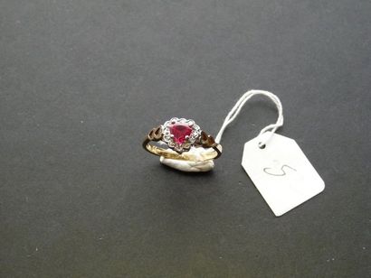 LOT Two-tone 9K (375/oo) gold ring centered with a heart cut synthetic ruby surrounded...
