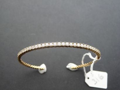 null Open semi-stiff band bracelet in 18K yellow gold (750/oo) set with a line of...