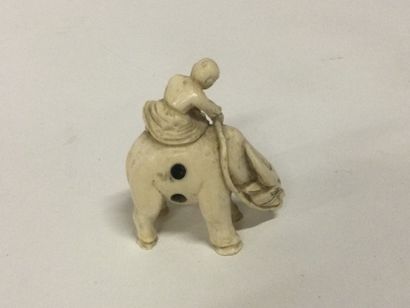 null JAPAN. A carved ivory netsuke with a figure on an ox, signature on the bottom,...