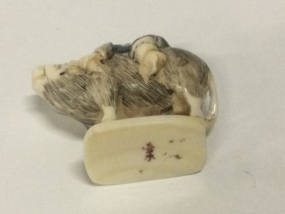 null JAPAN. A carved ivory netsuke showing a character riding an animal, polychrome...