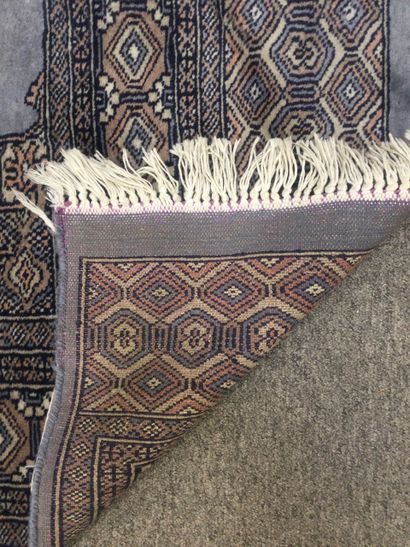 null PAKISTAN, Tapis noué main en laine à décor d'un médaillon central dans les tons...