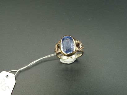 null BAGUE en or 18K (750/oo) de deux tons centrée d'un saphir ovale calibrant environ...