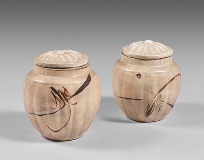 null 109- Two Cizhou type covered stoneware pots with ribbed walls and stylized floral...