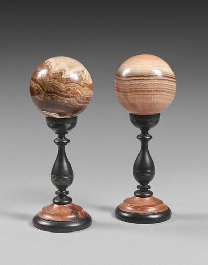 76- Two hard stone balls 
Turned wooden foot...