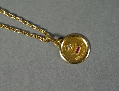 null 85- Gold "love medal" pendant set with small rubies and diamonds, held by a...