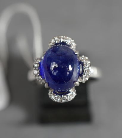 null 108- Gold ring with a cabochon sapphire set with baguette diamonds and brilliants...