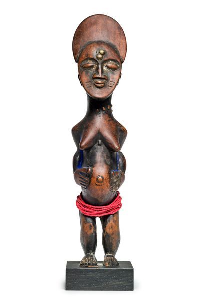 null Female wooden statue with brown patina, traces of methylene blue and
Ashanti...