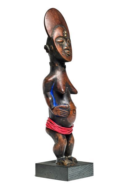 null Female wooden statue with brown patina, traces of methylene blue and
Ashanti...