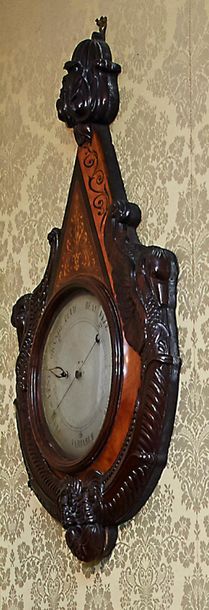 null Barometer in mahogany carved with swan necks and light wood inlaid with foliage...