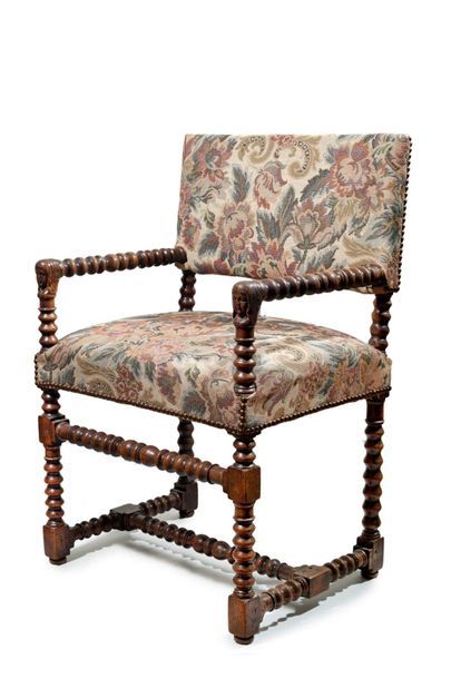 null Walnut armchair with flat back and turned uprights. End of armrests with female...