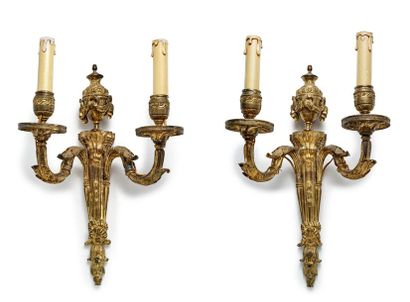 null Pair of chased and gilded bronze sconces with two light arms decorated with...