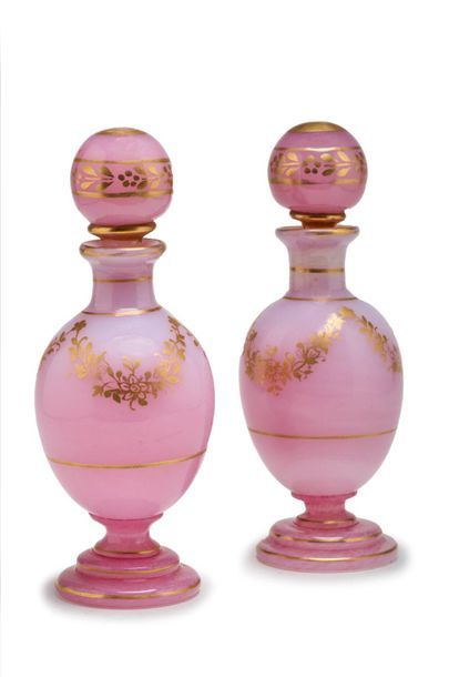 null Pair of ovoid bottles in pink opaline and gold with garland decoration.
Mid...