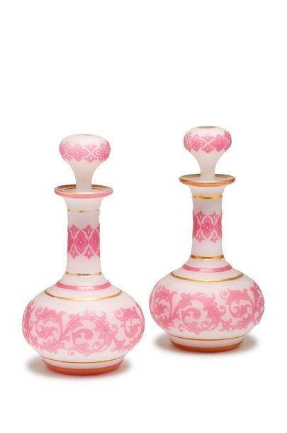 null Pair of flat-bellied white and pink opaline bottles with an openwork design...