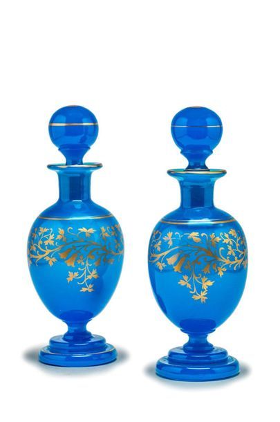 null Pair of ovoid blue and gold opaline bottles with scroll decoration.
Mid 19th...