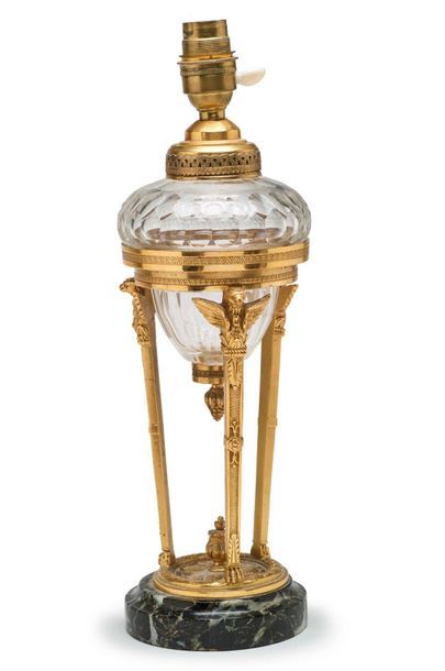 null Lamp in chased bronze, gilt and cut glass resting on three uprights terminated...