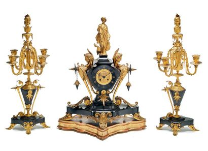 null Gilded bronze and black marble mantel set comprising:
A trapezoid clock with...