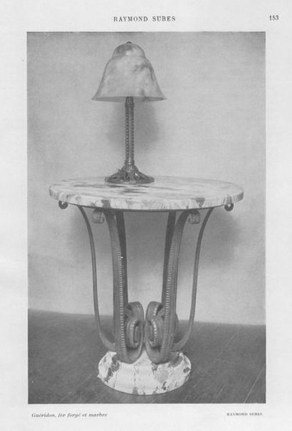 Raymond SUBES (1893-1970) 
Wrought iron pedestal table with a marble top resting...