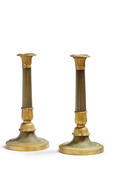 null Pair of chased and gilt bronze torches with leaf decoration and fluted shaft....