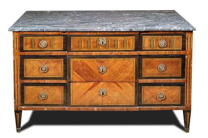 null Veneer chest of drawers with a central overhang opening by three rows of drawers....