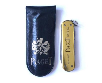 null Folding pocket knife. Piaget's watch, a blade and a chisel. Golden metal flasks....