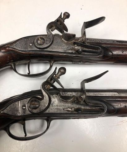 null Pair of flintlock pistols. Locks signed "Jean GOURGOULIAT" and flat-bodied swan-necked...
