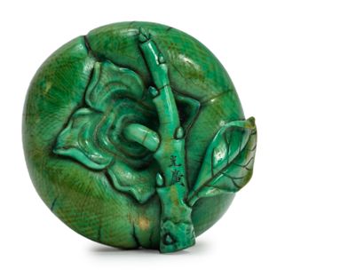 JAPON - XIXE SIÈCLE * Netsuke en ivoire teinté vert figurant un kaki accroché à une...