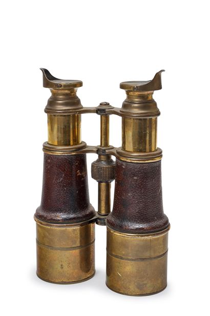 null Pair of marine binoculars in polished brass, body covered with leather
Early...