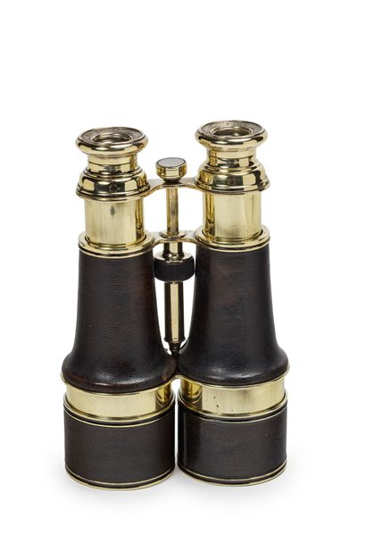 null Large pair of brass binoculars, black leather covered body and sun visor, orientation...