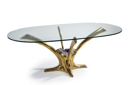 JACQUES DUVAL BRASSEUR (né en 1934) 
Table with oval glass top resting on a gilded...