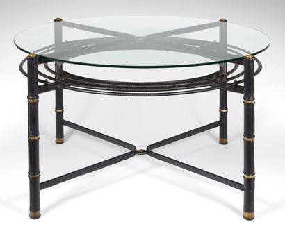 JACQUES ADNET (1900-1984) 
Dining room table with a circular glass top resting on...