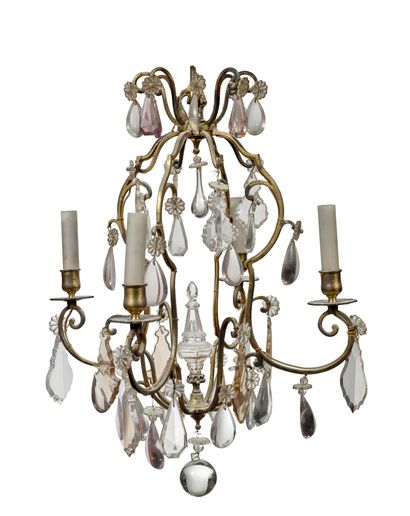null A four arms gilt bronze cage chandelier with crystal ornaments such as pendants,...