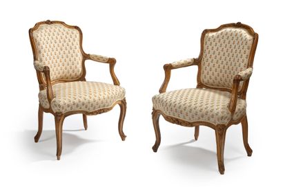 null 
Pair of cabriolet armchairs in natural wood, moulded and carved with leaves...