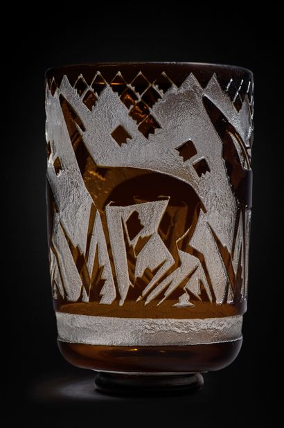 DAUM NANCY FRANCE 


A thick black tinted glass vase decorated with a frieze of deer...