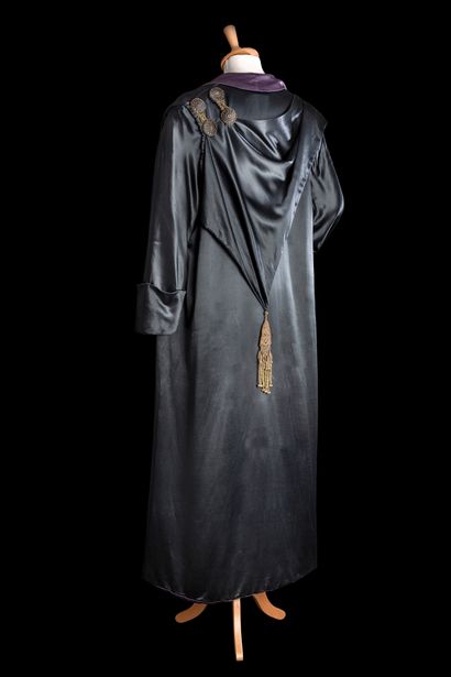 null 
Black silk satin evening coat, draped asymmetrically on the left side, held...