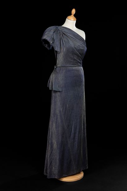 null 
Evening dress in blue and silver Lurex with an asymmetrical bodice starting...