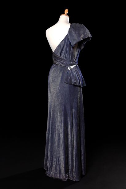 null 
Evening dress in blue and silver Lurex with an asymmetrical bodice starting...