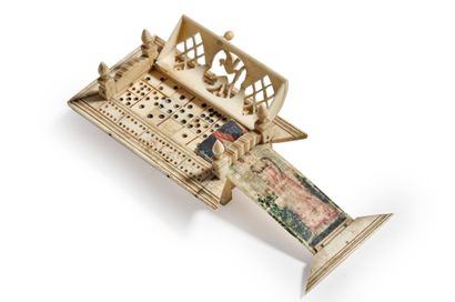 null Bone domino game in its box with hinged lid and pull tab with painted decoration...