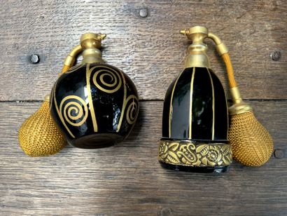 null Two perfume bottles in black tinted glass and painted with gold with floral...