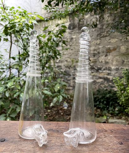 Two transparent colorless glass bird feeders....